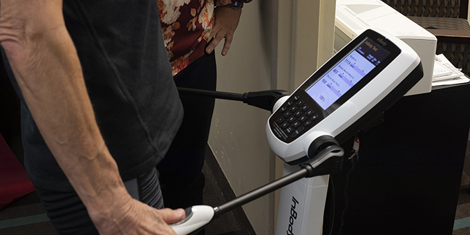 man holding onto handles of inbody machine