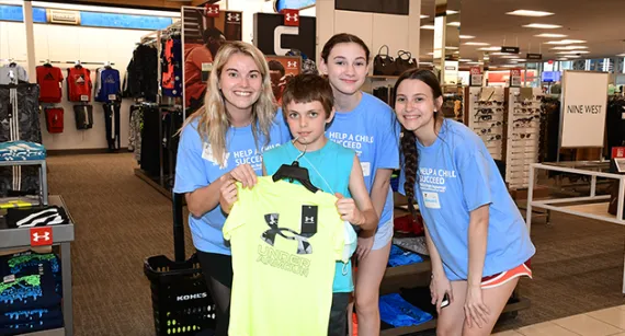 Young adults shopping for a young boy 
