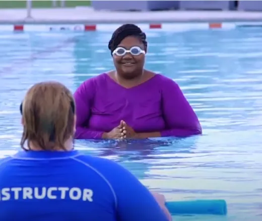 women learning how to swim in a pool