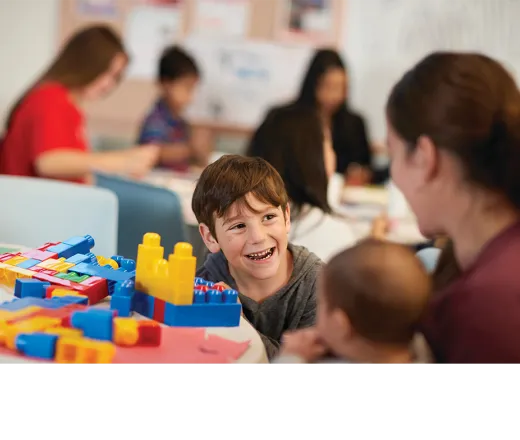 child playing with blocks on a table