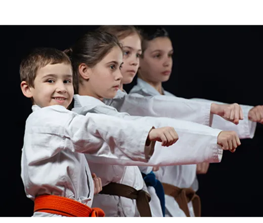 four kids doing martial arts