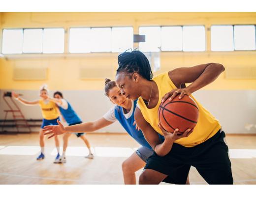 Adults playing basketball