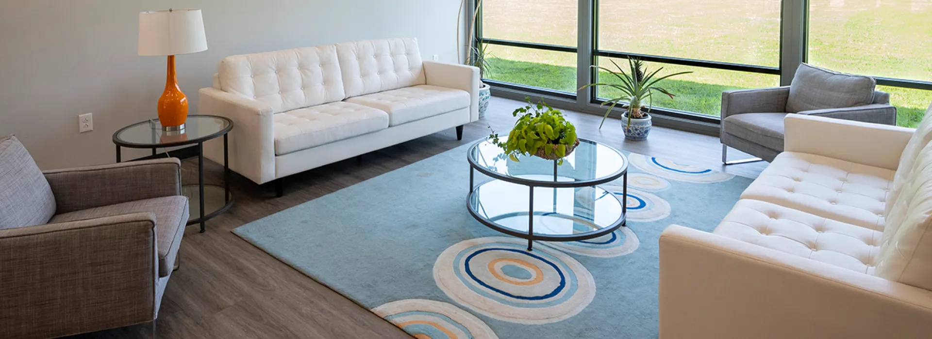 Sitting area with chairs and tables with a window