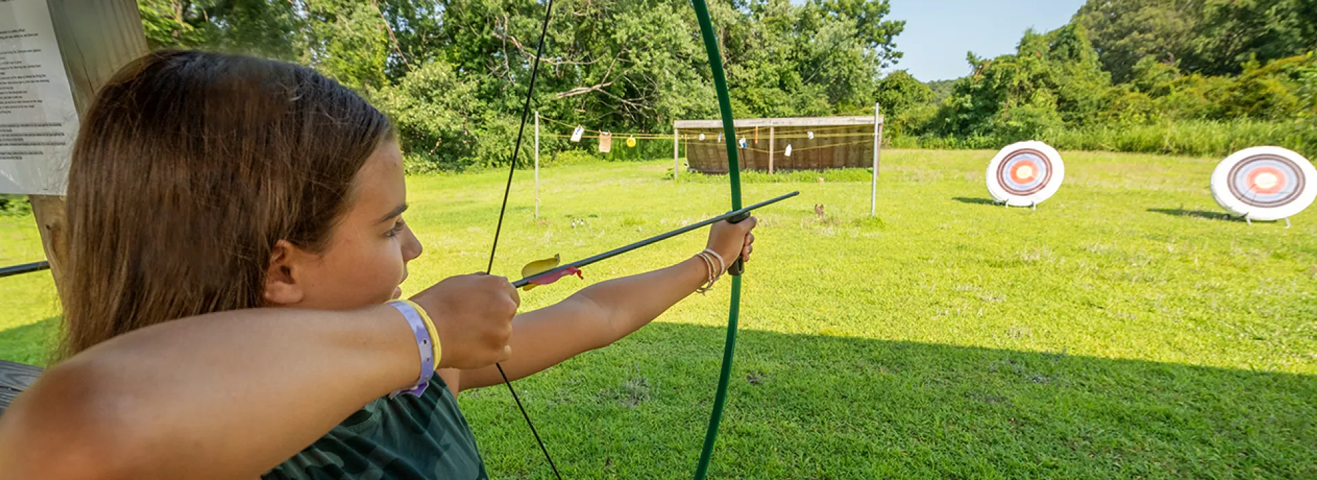 Camper girl doing archery