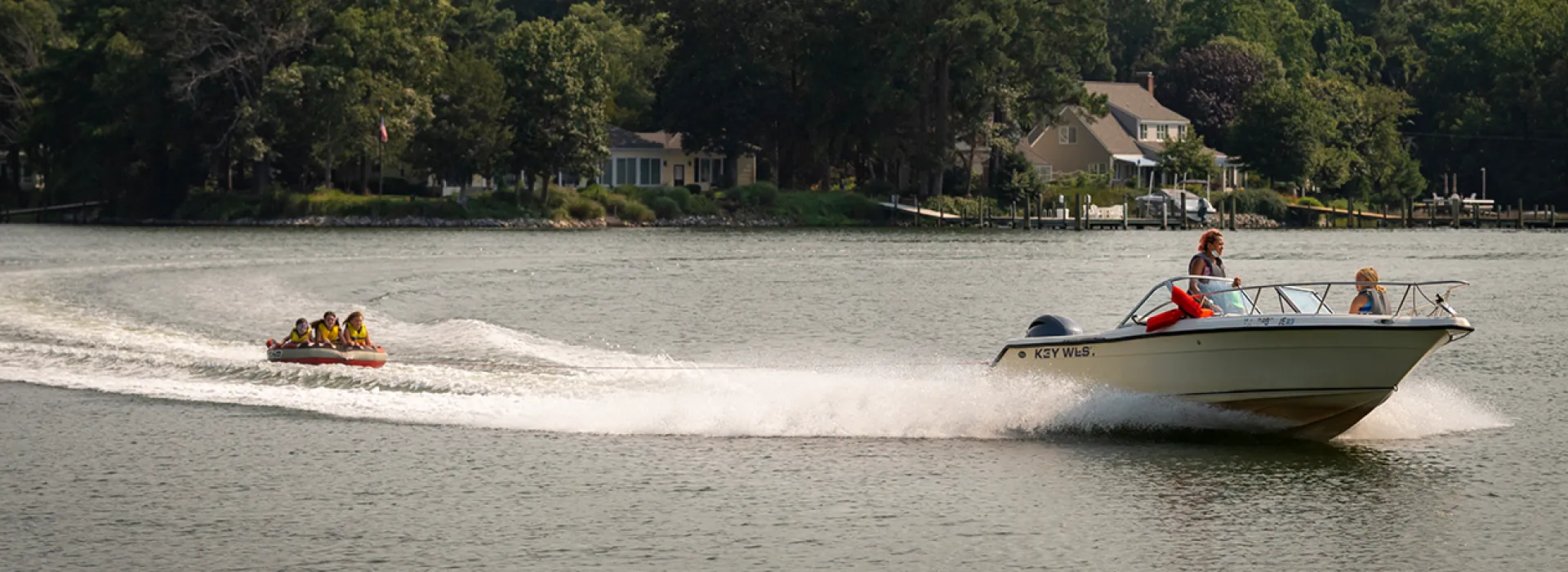 Kids tubing behind a boat