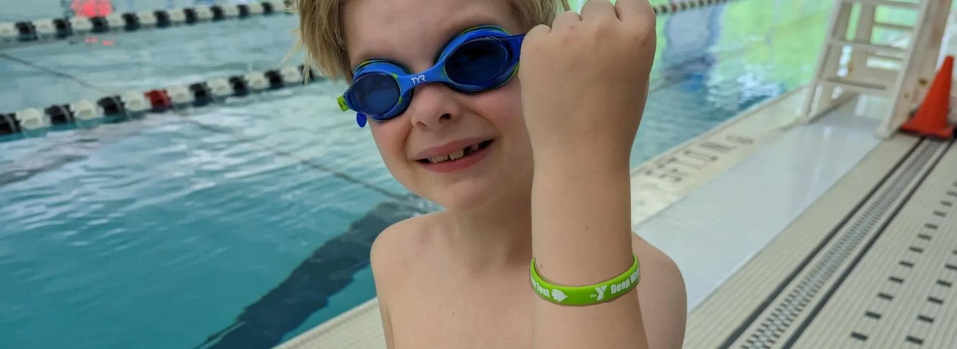 Swimmer Holding Up Green Arm Band
